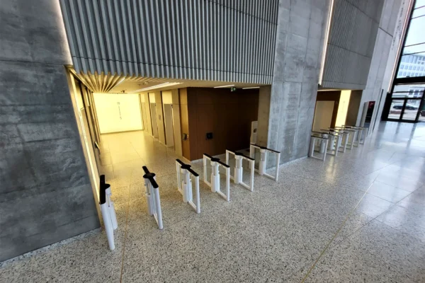 Optical turnstiles in high-ceiling lobby Optical turnstiles in a high-ceiling lobby with stone walls