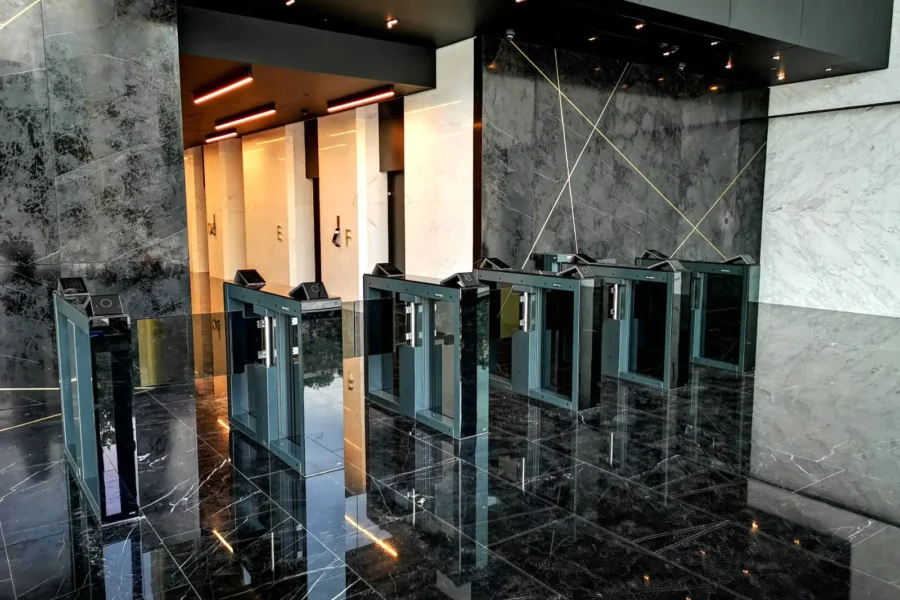 Optical turnstiles in a lobby with dark marble finishes